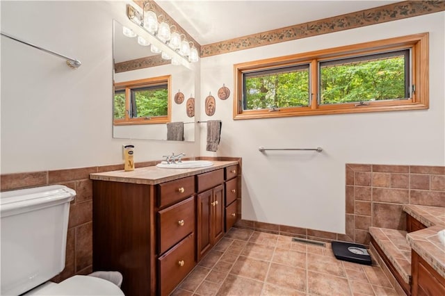 9926 W Birch Circle Dr, Ladysmith, WI 54848 - full bathroom featuring healthy amount of natural light, vanity, tile walls, and tile patterned floors