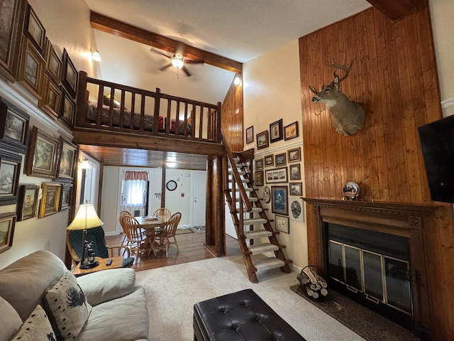 8 Balsam Trl, Wisconsin Dells, WI 53965 - living room with stairs, a glass covered fireplace, wooden walls, carpet floors, and ceiling fan