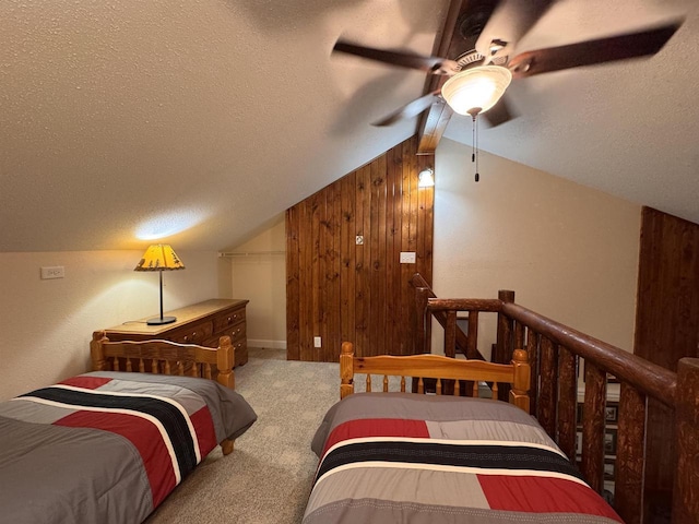 8 Balsam Trl, Wisconsin Dells, WI 53965 - bedroom with a textured ceiling, carpet, vaulted ceiling, wooden walls, and a ceiling fan