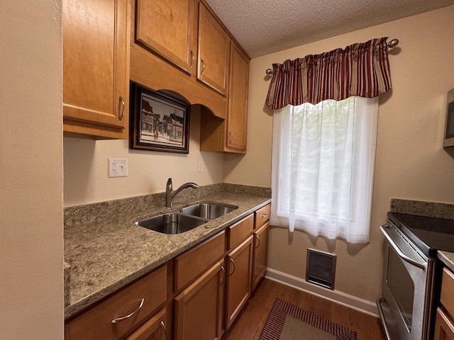 8 Balsam Trl, Wisconsin Dells, WI 53965 - kitchen with stainless steel range with electric stovetop, dark wood-type flooring, brown cabinets, a textured ceiling, and stone countertops