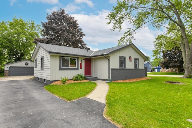 6913 Butternut Rd, Racine, WI 53402 - single story home featuring an outbuilding, a detached garage, a front lawn, roof with shingles, and brick siding