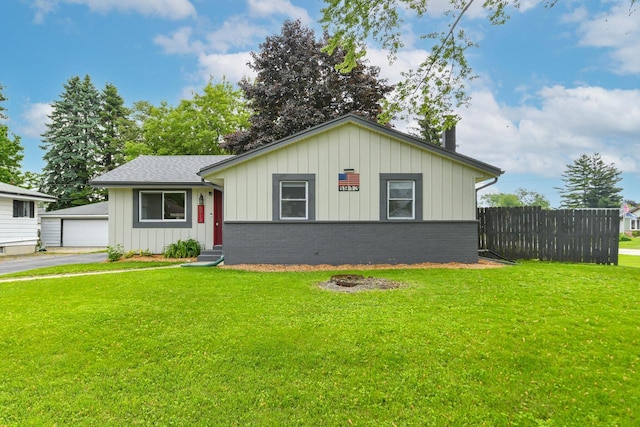 6913 Butternut Rd, Racine, WI 53402 - view of front of home with brick siding, board and batten siding, a garage, entry steps, and an outbuilding