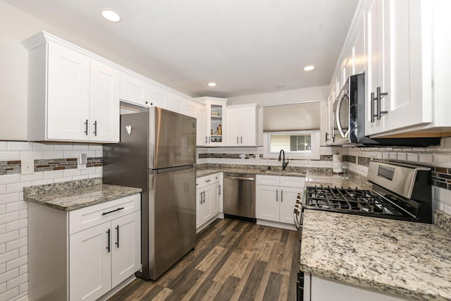 6913 Butternut Rd, Racine, WI 53402 - kitchen featuring stainless steel appliances, dark wood-style floors, white cabinets, light stone counters, and decorative backsplash