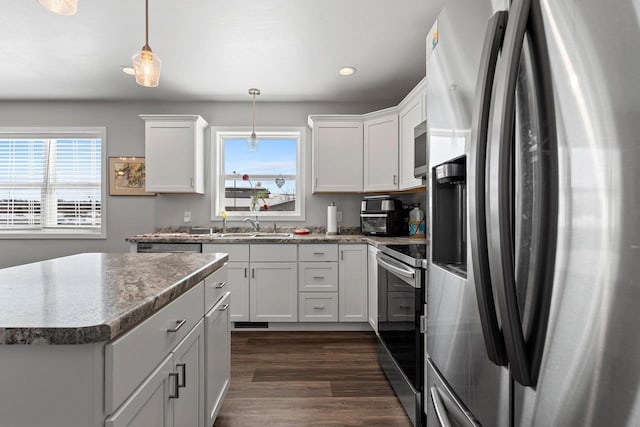 400 Tristan Dr, Shawano, WI 54166 - kitchen featuring stainless steel appliances, healthy amount of natural light, recessed lighting, dark wood-style flooring, and decorative light fixtures