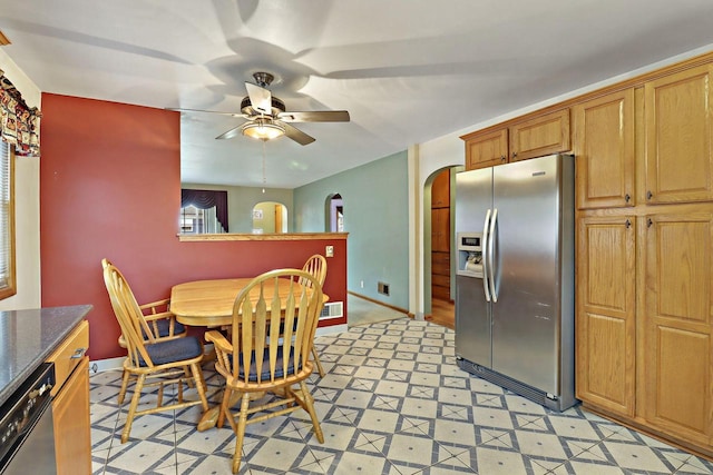 7631 38th Ave, Kenosha, WI 53142 - dining space with arched walkways, light flooring, and a ceiling fan
