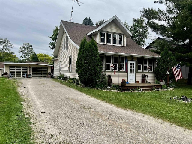 808 Fremont St, Fremont, WI 54940 - view of front of home with an outdoor structure, roof with shingles, a front yard, and a garage