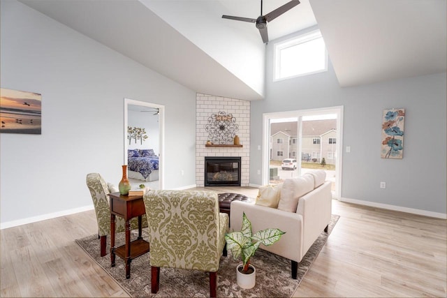 922 Vogt Ln, Chilton, WI 53014 - living area featuring high vaulted ceiling, ceiling fan, light wood-style flooring, and a brick fireplace