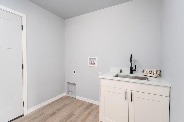 922 Vogt Ln, Chilton, WI 53014 - laundry room with washer hookup, electric dryer hookup, light wood-style flooring, and cabinet space