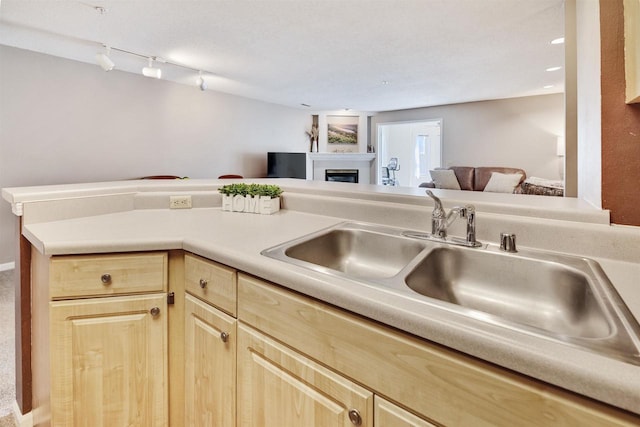 8530 Greenway Blvd Unit 104, Middleton, WI 53562 - kitchen with light brown cabinets, open floor plan, a fireplace, and light countertops