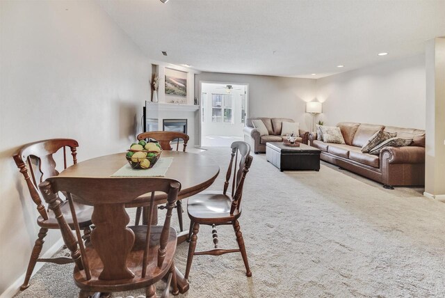 8530 Greenway Blvd Unit 104, Middleton, WI 53562 - dining area with a glass covered fireplace, carpet flooring, recessed lighting, and ceiling fan
