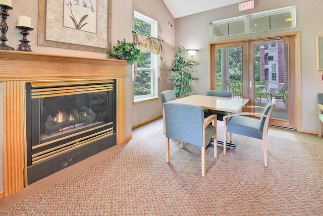 8530 Greenway Blvd Unit 104, Middleton, WI 53562 - dining space with carpet, vaulted ceiling, and a glass covered fireplace