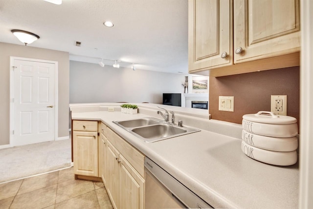 8530 Greenway Blvd Unit 104, Middleton, WI 53562 - kitchen featuring light brown cabinets, light countertops, light tile patterned flooring, light carpet, and a glass covered fireplace