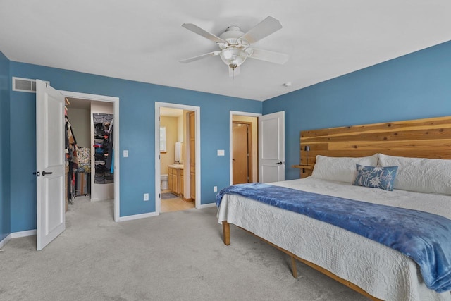 4140 W Lakeview Dr, Franklin, WI 53132 - carpeted bedroom featuring a walk in closet, a closet, ensuite bathroom, and ceiling fan