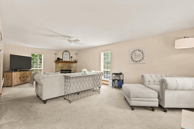4140 W Lakeview Dr, Franklin, WI 53132 - living area featuring a ceiling fan, a stone fireplace, and light carpet