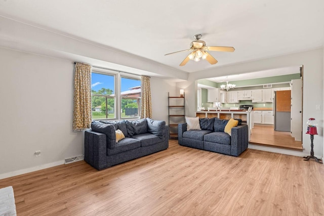W330S7517 Split Rail Dr, Mukwonago, WI 53149 - living room featuring a chandelier, ceiling fan, and light wood-type flooring