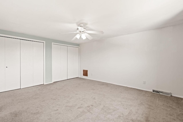W330S7517 Split Rail Dr, Mukwonago, WI 53149 - unfurnished bedroom featuring two closets, carpet floors, and ceiling fan