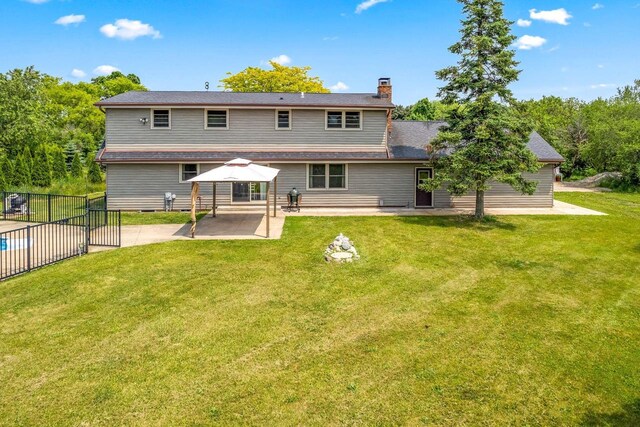 W330S7517 Split Rail Dr, Mukwonago, WI 53149 - rear view of house featuring a gazebo, a patio area, and a chimney