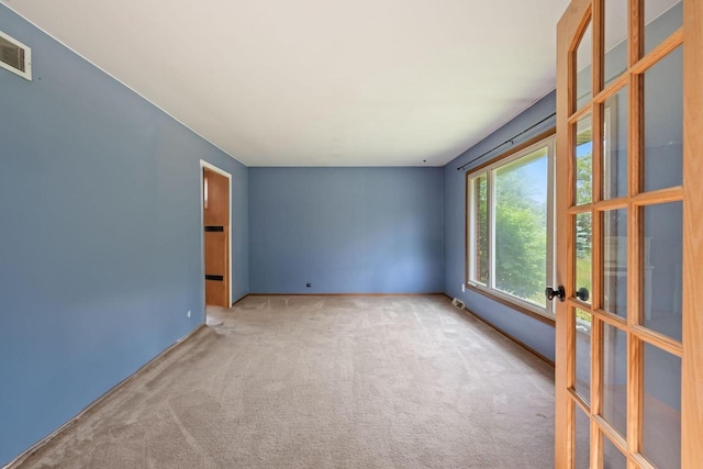 W330S7517 Split Rail Dr, Mukwonago, WI 53149 - spare room featuring carpet and french doors