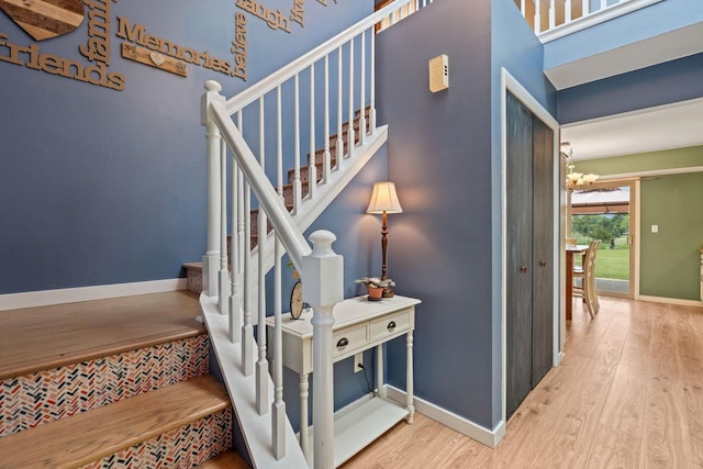 W330S7517 Split Rail Dr, Mukwonago, WI 53149 - staircase featuring wood finished floors and a chandelier