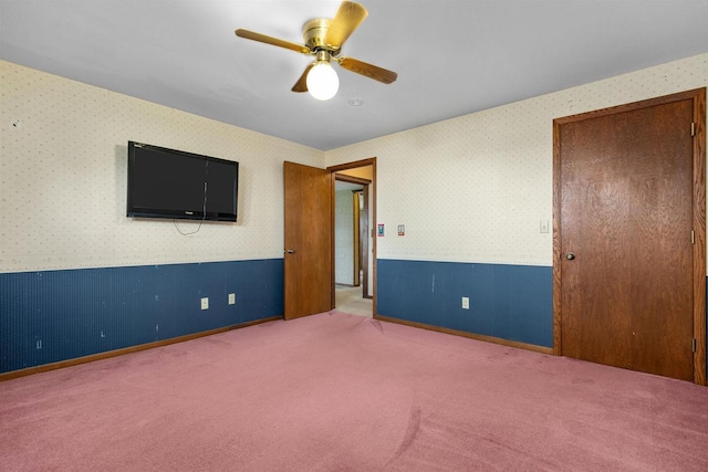 6352 Black Wolf Point Ln, Oshkosh, WI 54902 - unfurnished bedroom with wallpapered walls, carpet floors, and a ceiling fan
