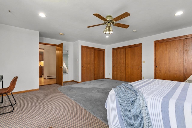6352 Black Wolf Point Ln, Oshkosh, WI 54902 - carpeted bedroom featuring multiple closets, a baseboard radiator, recessed lighting, and a ceiling fan