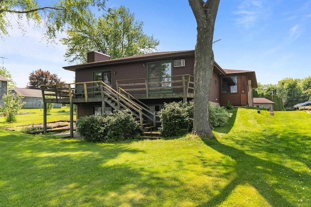 6352 Black Wolf Point Ln, Oshkosh, WI 54902 - back of property with stairway, a wooden deck, a chimney, and a lawn