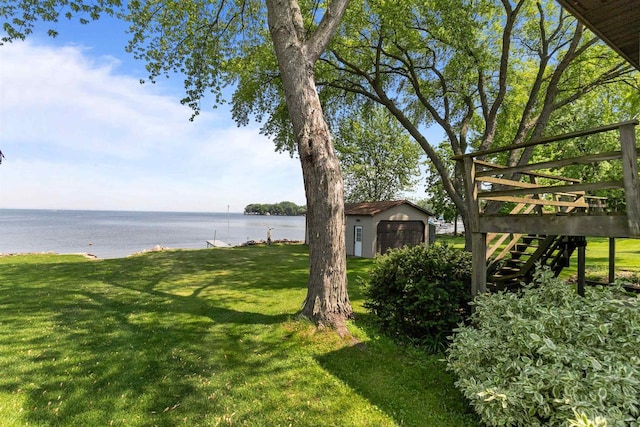 6352 Black Wolf Point Ln, Oshkosh, WI 54902 - view of green lawn with an outbuilding, a deck with water view, and stairs