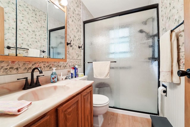38 Bowen St, Oshkosh, WI 54901 - full bath featuring wallpapered walls, wood finished floors, vanity, and a stall shower