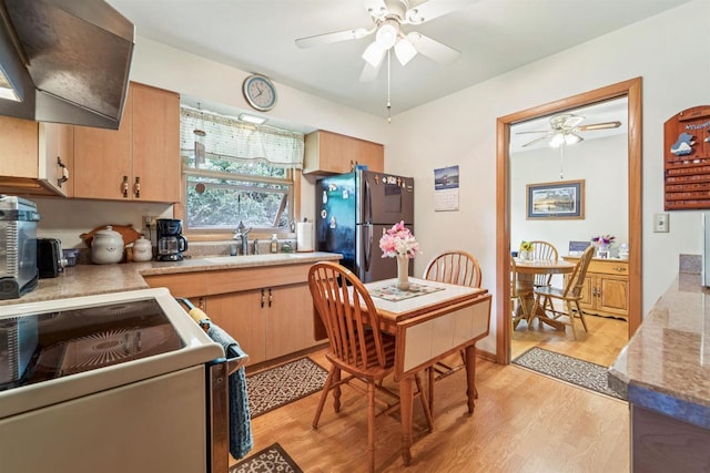 38 Bowen St, Oshkosh, WI 54901 - kitchen with a ceiling fan, range hood, freestanding refrigerator, light wood-type flooring, and white electric range oven
