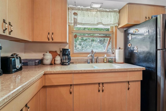 38 Bowen St, Oshkosh, WI 54901 - kitchen with freestanding refrigerator and light brown cabinets