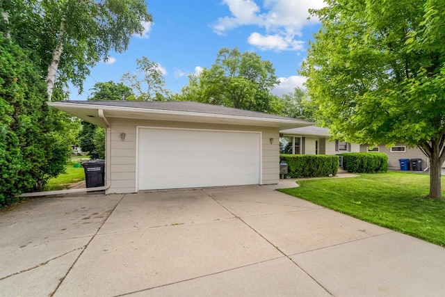 38 Bowen St, Oshkosh, WI 54901 - view of front of house with a front yard, concrete driveway, and an attached garage