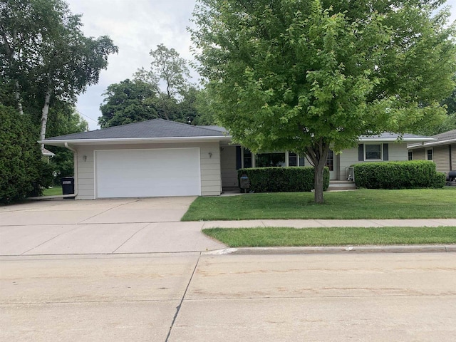 38 Bowen St, Oshkosh, WI 54901 - view of front of home featuring an attached garage, driveway, and a front lawn