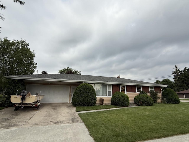317 Reed St, Chilton, WI 53014 - ranch-style house featuring driveway, an attached garage, and a front lawn