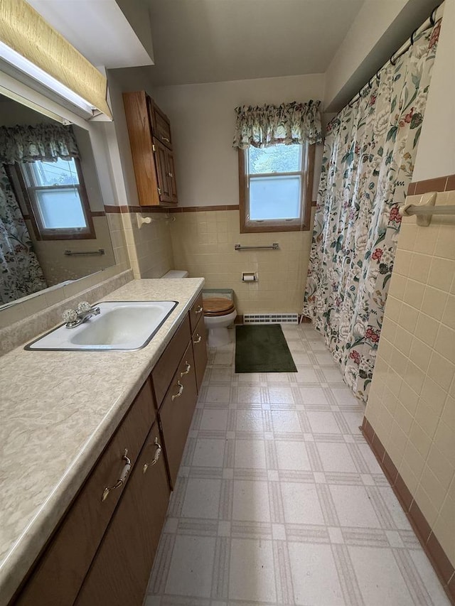 317 Reed St, Chilton, WI 53014 - bathroom featuring tile walls, a wainscoted wall, vanity, and tile patterned floors
