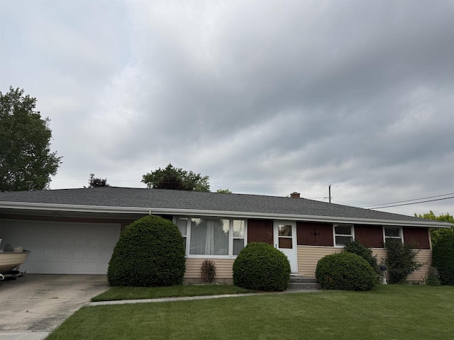 317 Reed St, Chilton, WI 53014 - single story home featuring an attached garage, a front lawn, concrete driveway, and a shingled roof