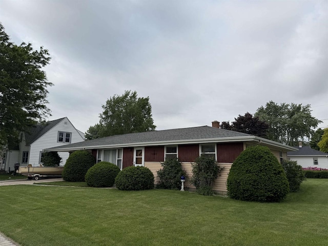 317 Reed St, Chilton, WI 53014 - ranch-style home with a front yard and a chimney