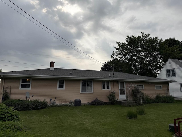 317 Reed St, Chilton, WI 53014 - back of house with a lawn and a chimney