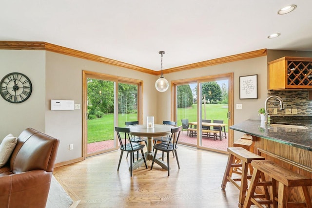 W151N10146 W Windsong Cir, Germantown, WI 53022 - dining space featuring light wood-style floors, ornamental molding, and recessed lighting