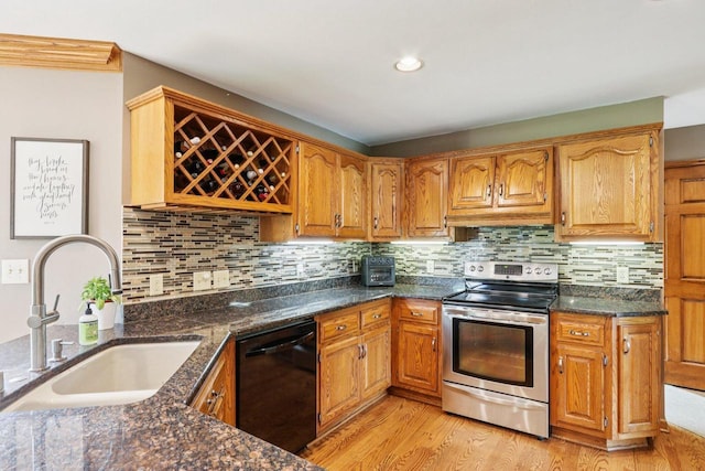 W151N10146 W Windsong Cir, Germantown, WI 53022 - kitchen with dishwasher, stainless steel range with electric cooktop, light wood finished floors, dark stone countertops, and backsplash