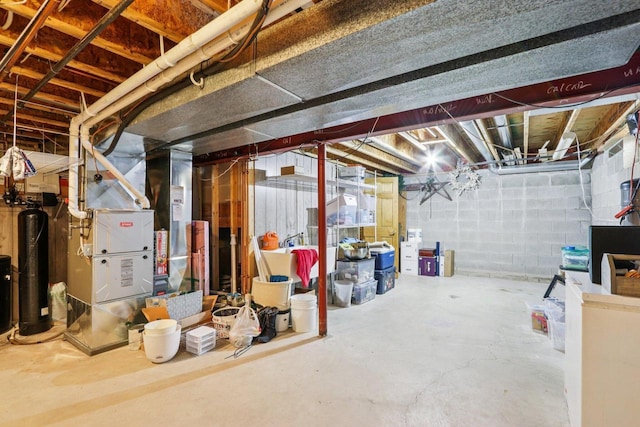 W151N10146 W Windsong Cir, Germantown, WI 53022 - unfinished basement with a water softener system, heating unit, and concrete block wall
