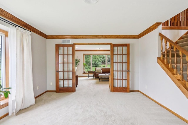 W151N10146 W Windsong Cir, Germantown, WI 53022 - carpeted empty room featuring french doors, ornamental molding, and stairway