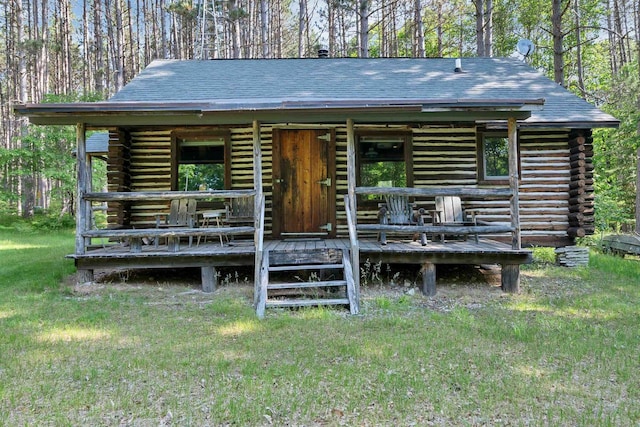 N14066 Squaw Creek Rd, Wausaukee, WI 54177 - log home featuring log exterior, a front yard, and a shingled roof