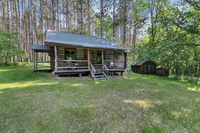 N14066 Squaw Creek Rd, Wausaukee, WI 54177 - back of property featuring log exterior, a storage shed, and a yard