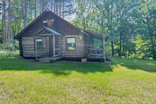 N14066 Squaw Creek Rd, Wausaukee, WI 54177 - view of front of house with log siding and a front lawn