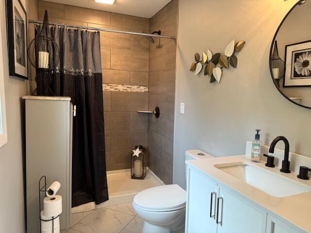 4005 86th Pl, Kenosha, WI 53142 - bathroom featuring vanity, a tile shower, and marble look tiles