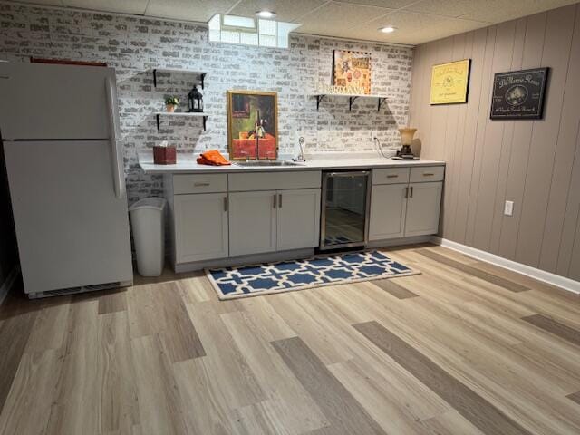 4005 86th Pl, Kenosha, WI 53142 - indoor wet bar with freestanding refrigerator, wine cooler, light wood finished floors, and a paneled ceiling