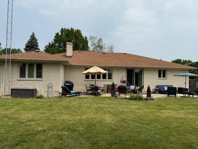 4005 86th Pl, Kenosha, WI 53142 - back of house featuring a chimney, a yard, and a patio
