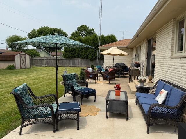 4005 86th Pl, Kenosha, WI 53142 - fenced backyard with an outdoor living space, a patio area, and a shed