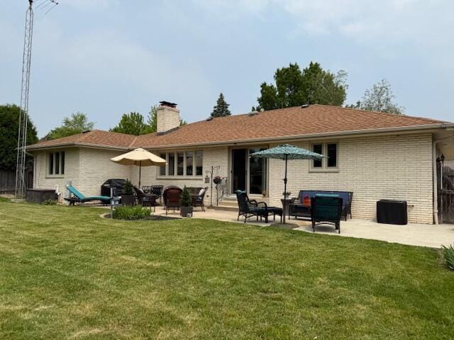 4005 86th Pl, Kenosha, WI 53142 - rear view of house featuring a chimney, brick siding, a patio area, and a yard