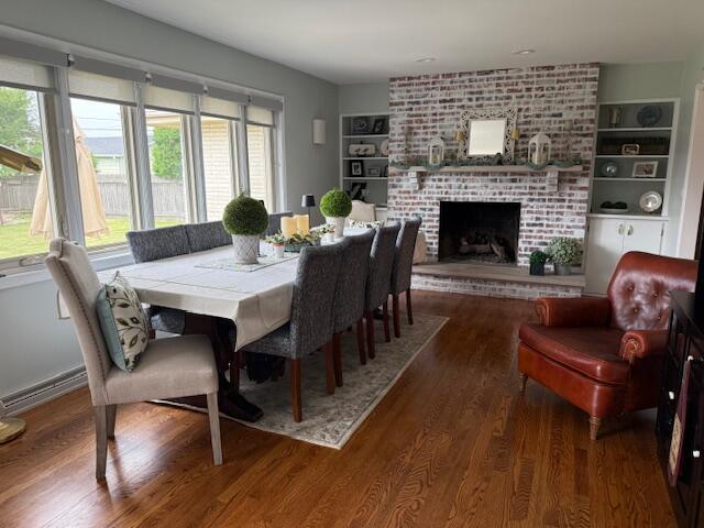 4005 86th Pl, Kenosha, WI 53142 - dining space featuring plenty of natural light, wood finished floors, a brick fireplace, and built in features